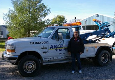 Lady Posing Besides Able Towing Vehicle