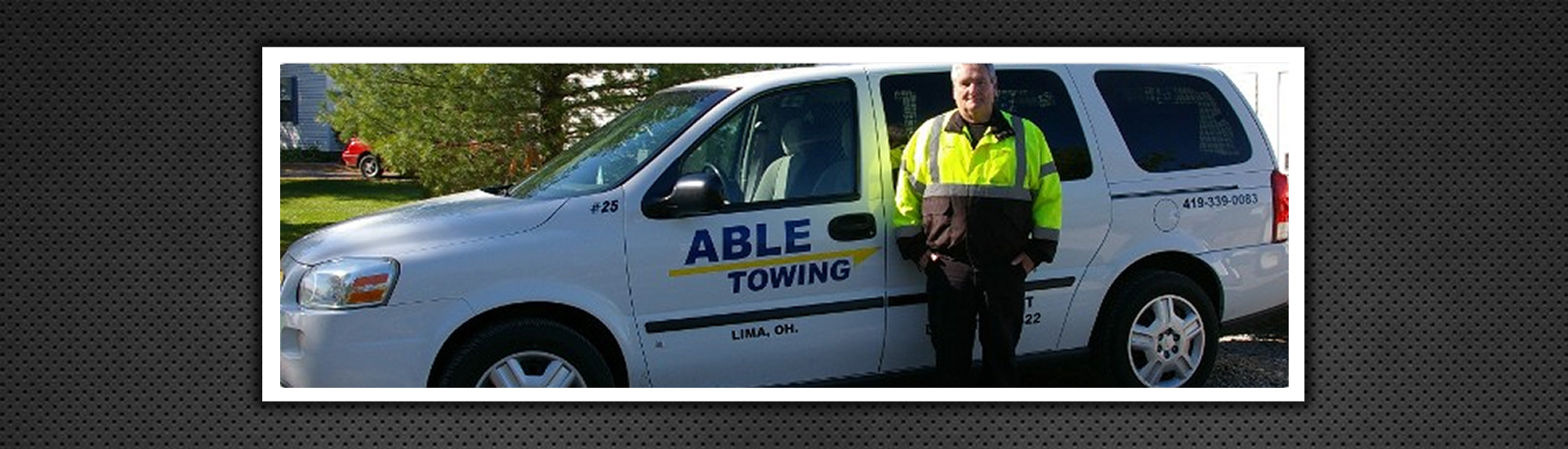 Professional Standing Infront of Able Towing Vehicle
