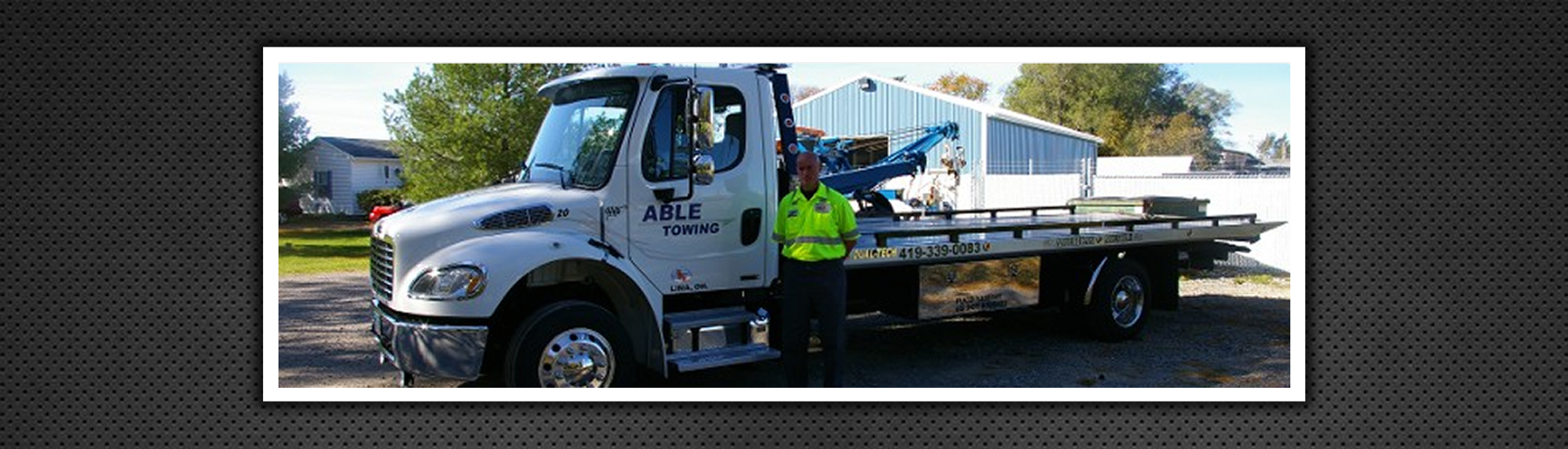 Man Standing Infront of Able Towing Vehicle
