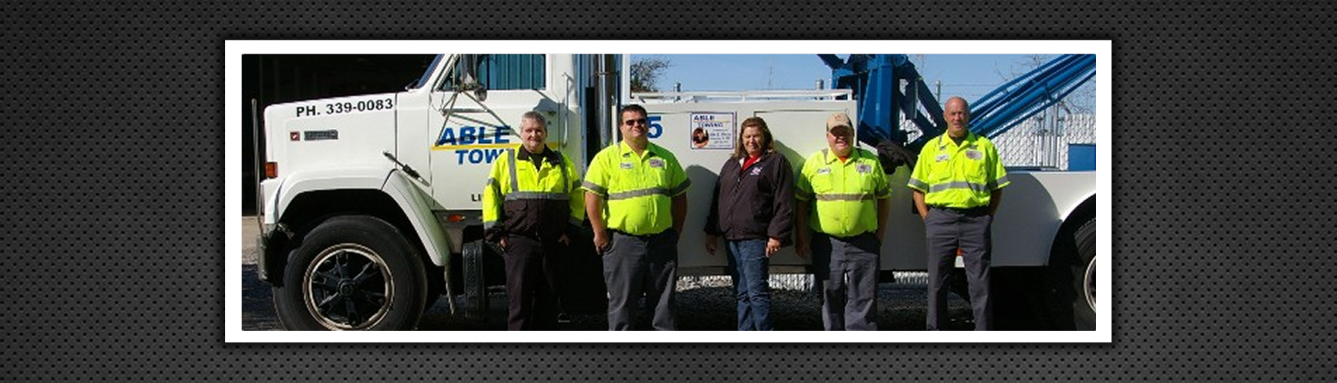 Able Towing Crew Posing Infront of Towing Vehicle